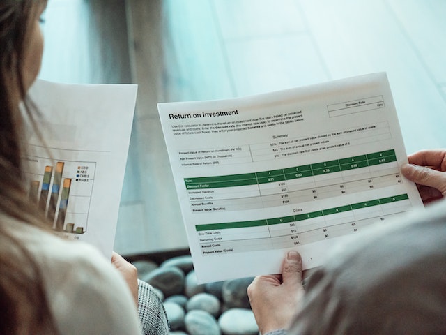 two people looking at a piece of paper