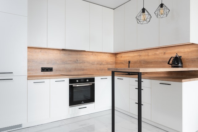 white kitchen with wooden panels