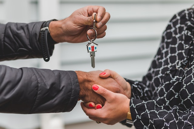 shaking hands and exchanging a house key